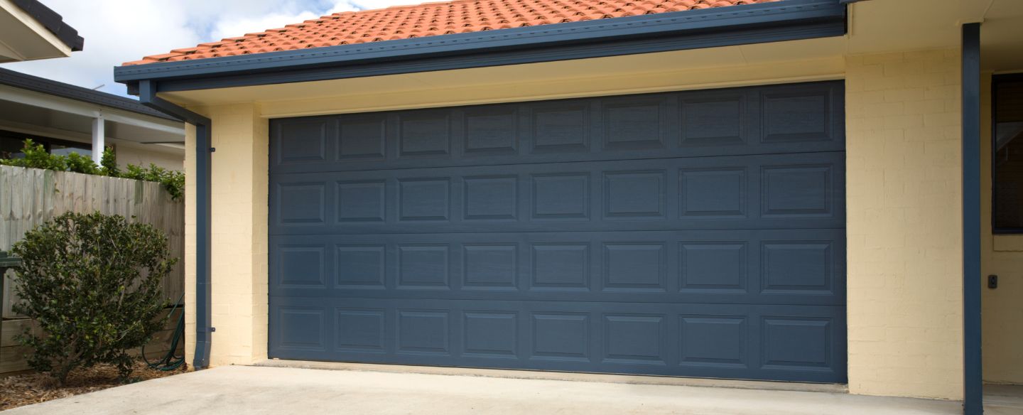 a blue double garage door on a home lansing mi